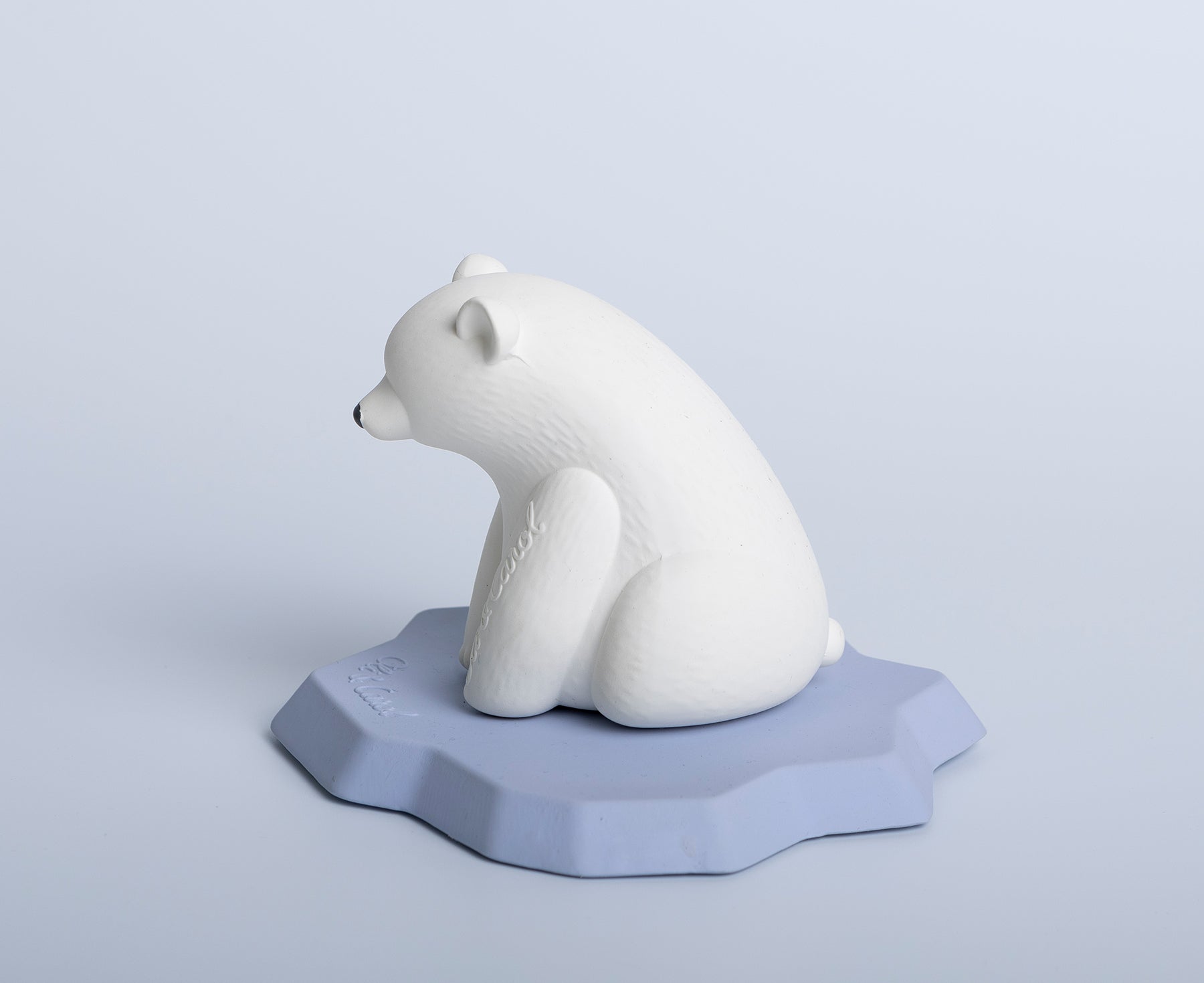 White polar bear chewable toy on a blue base of ice by Oli & Carol.