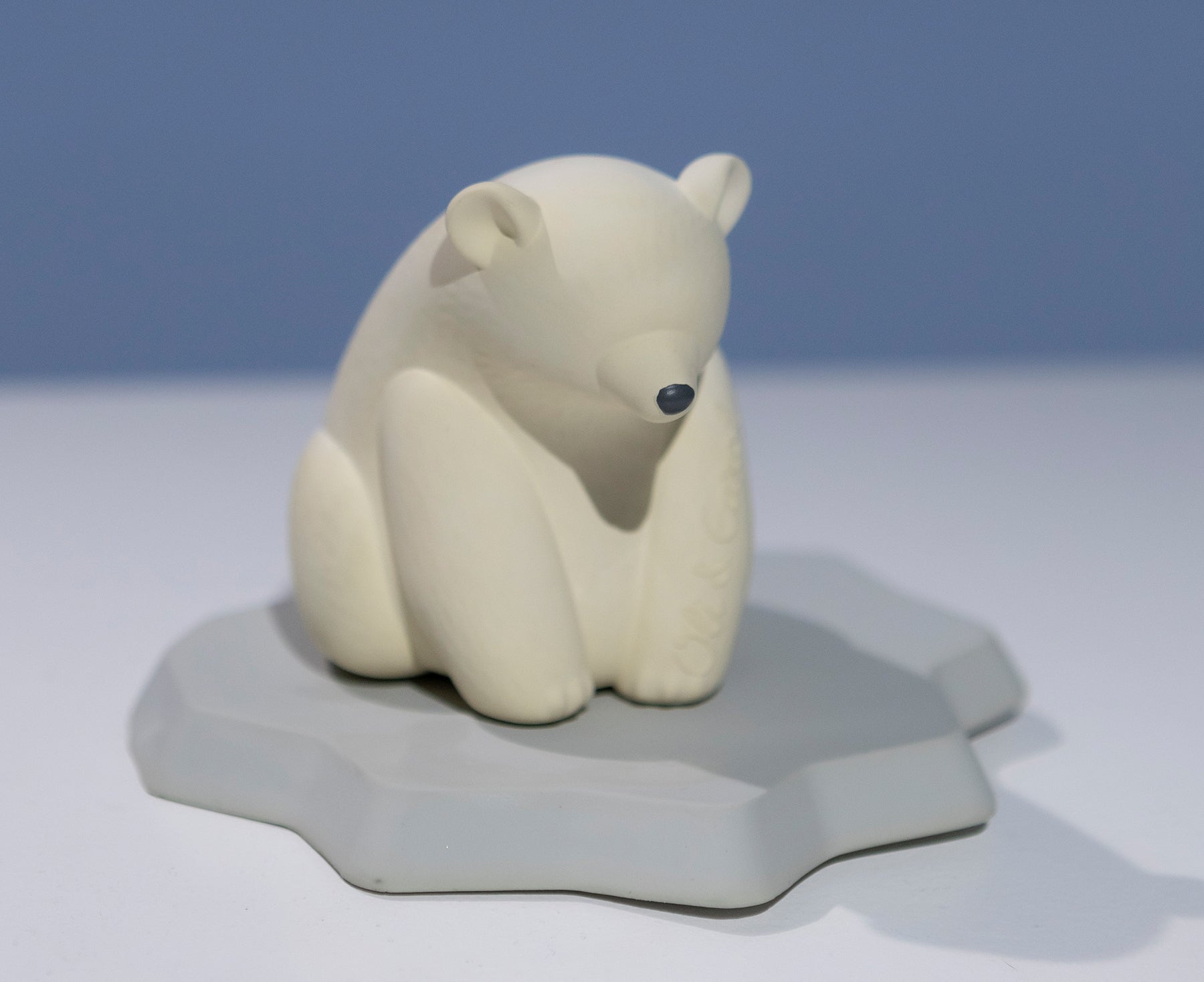 White polar bear chewable toy on a blue base of ice by Oli & Carol.